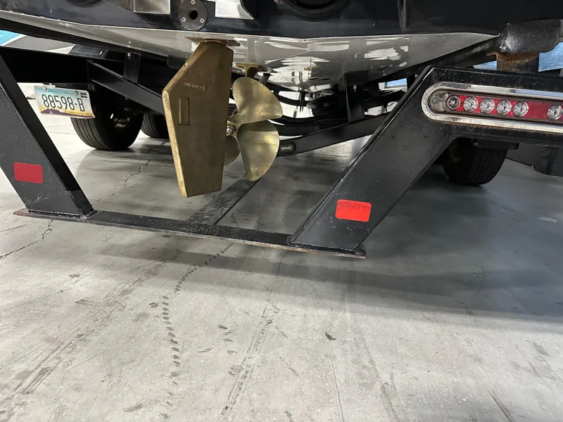 Slide: The Image of 2010 Malibu Wakesetter 247 LSV boat propeller and trailer detail in a garage setting. - 6