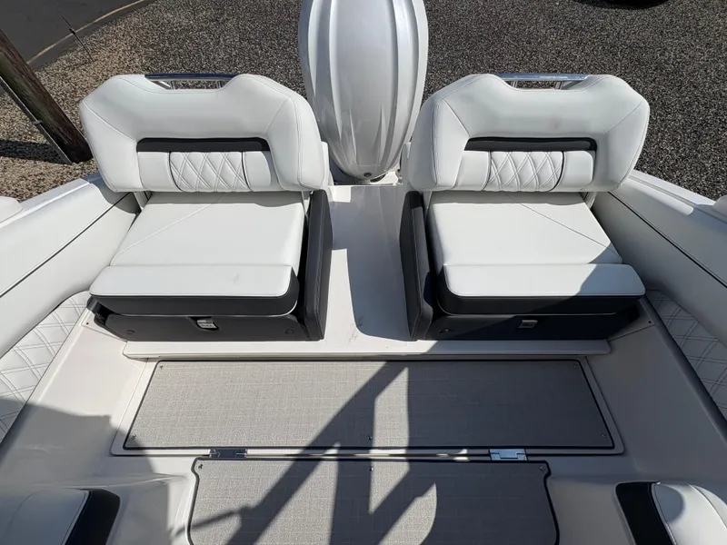 Slide: The Image of 2025 Regal LX4 boat interior with white cushioned seats and sleek design. - 11