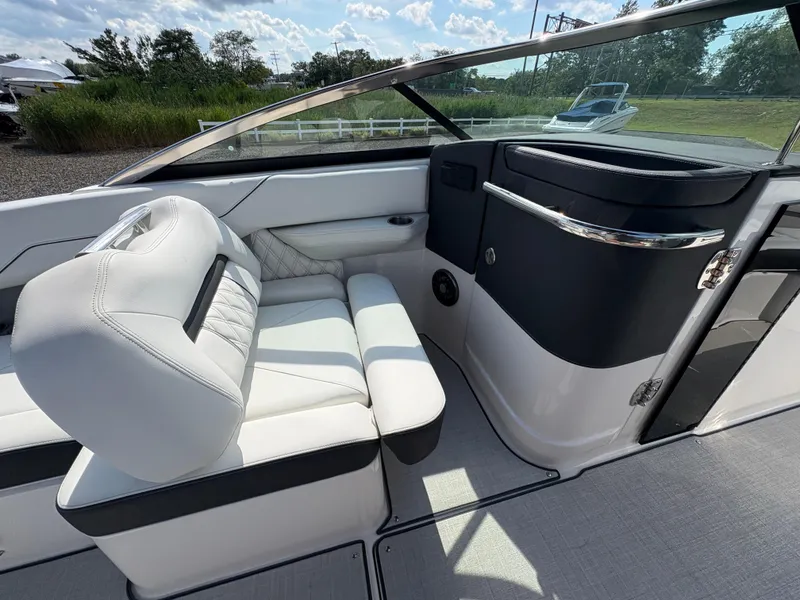 Slide: The Image of Luxurious interior of 2025 Regal LX4 boat with white leather seating and sleek design. - 18
