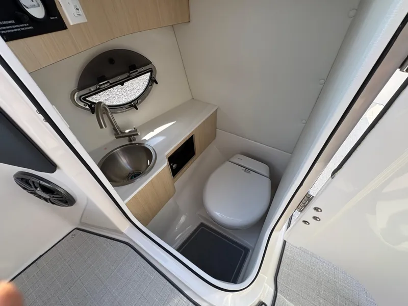 Slide: The Image of Compact bathroom in 2025 Regal LX4 boat with sink, toilet, and window. - 19