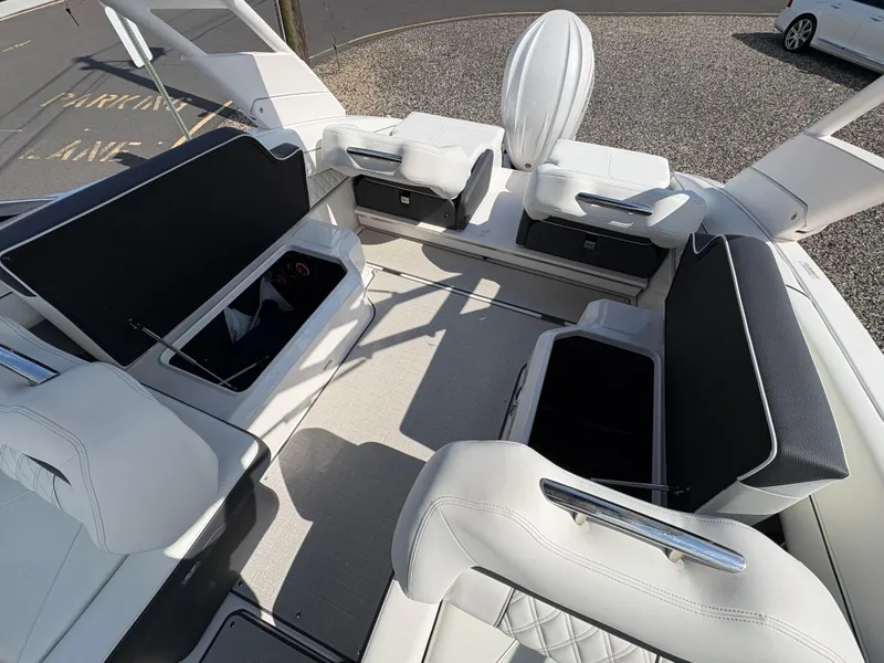 Slide: The Image of 2025 Regal LX4 boat interior with white seating and storage compartments. - 22