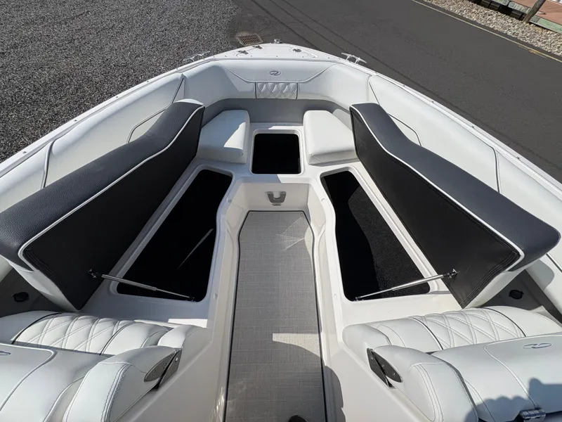 Slide: The Image of 2025 Regal LX4 boat interior with open storage compartments and cushioned seating. - 23