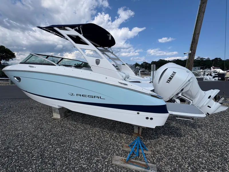 Slide: The Image of 2025 Regal LX4 boat with Yamaha engine on display, under a cloudy sky. - 4