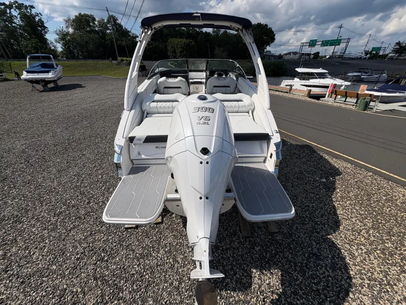 Slide: The Image of 2025 Regal LX4 boat with powerful 300 V8 engine, docked outdoors on gravel. - 5