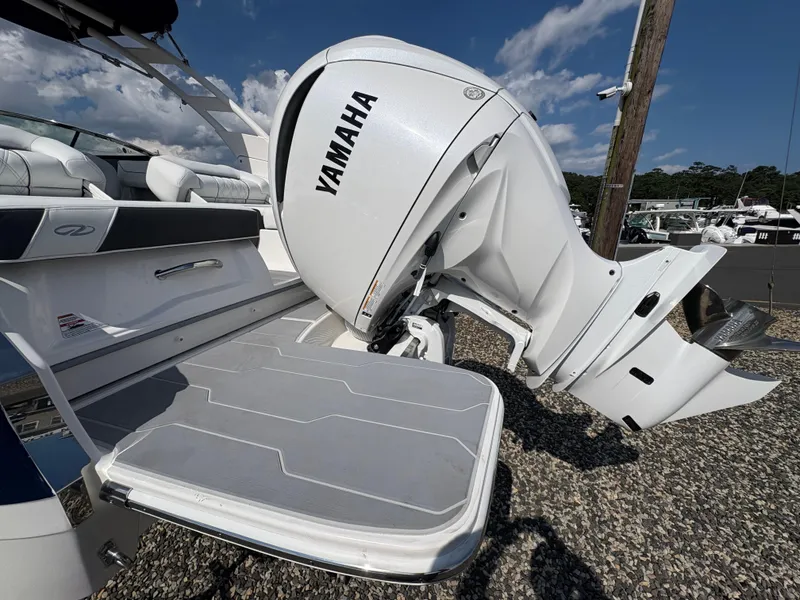 Slide: The Image of 2025 Regal LX4 boat with Yamaha outboard motor, docked under a clear sky. - 9