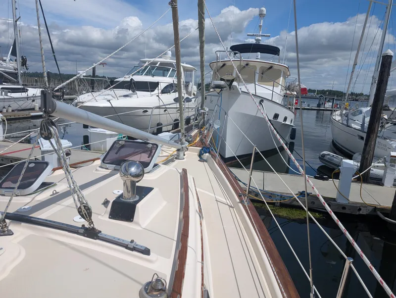 Slide: The Image of Sailboat docked at marina, Island Packet 35, 1994 model, surrounded by other boats. - 11