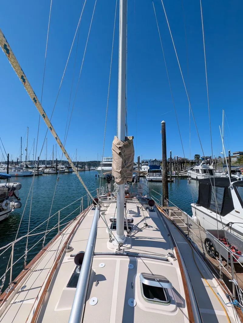 Slide: The Image of 1994 Island Packet 35 sailboat docked in a marina under clear blue skies. - 15