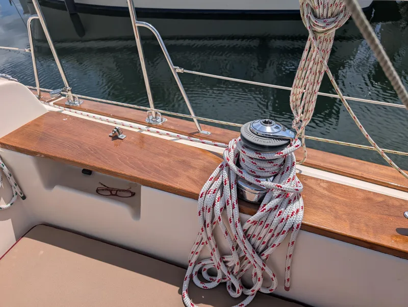 Slide: The Image of 1994 Island Packet 35 sailboat deck with winch and coiled rope. - 21
