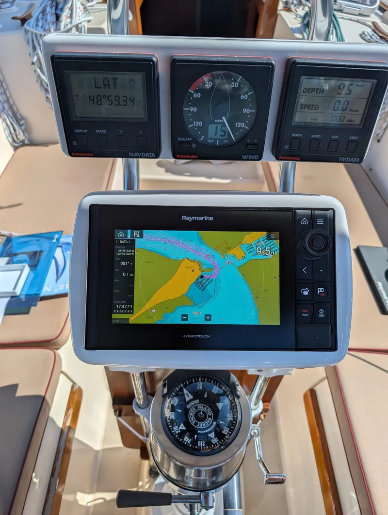 Slide: The Image of Navigation instruments on a 1994 Island Packet 35 sailboat, featuring Raymarine display and compass. - 23
