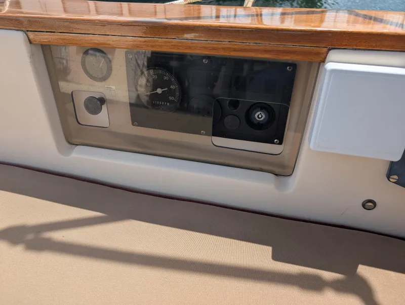 Slide: The Image of Control panel of a 1994 Island Packet 35 sailboat with wooden trim. - 25