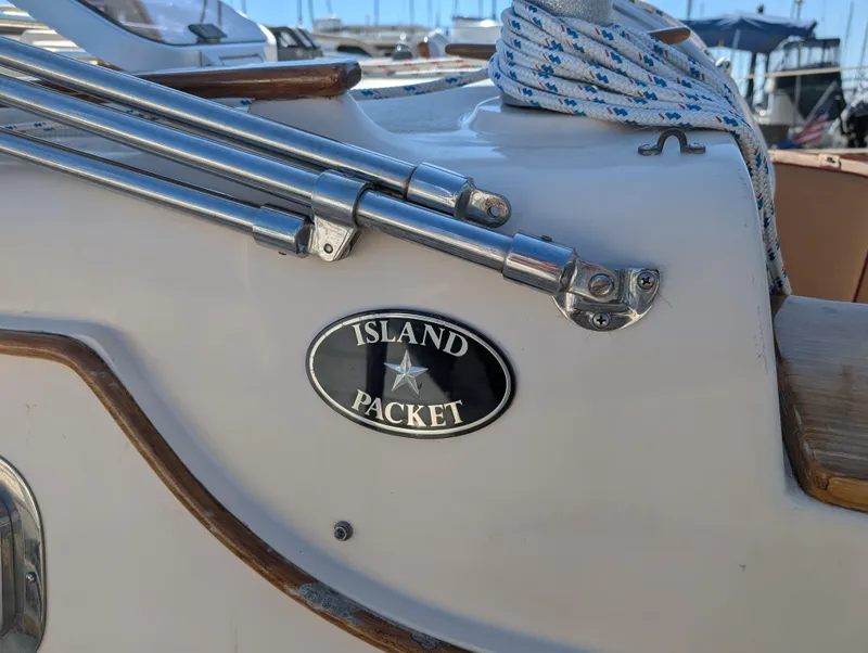Slide: The Image of Close-up of a 1994 Island Packet 35 sailboat with logo and rigging details. - 3