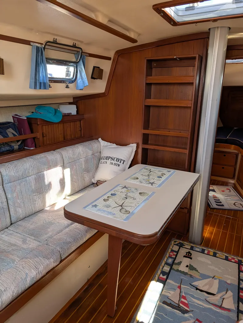 Slide: The Image of Cozy interior of 1994 Island Packet 35 sailboat with wooden accents and nautical decor. - 35