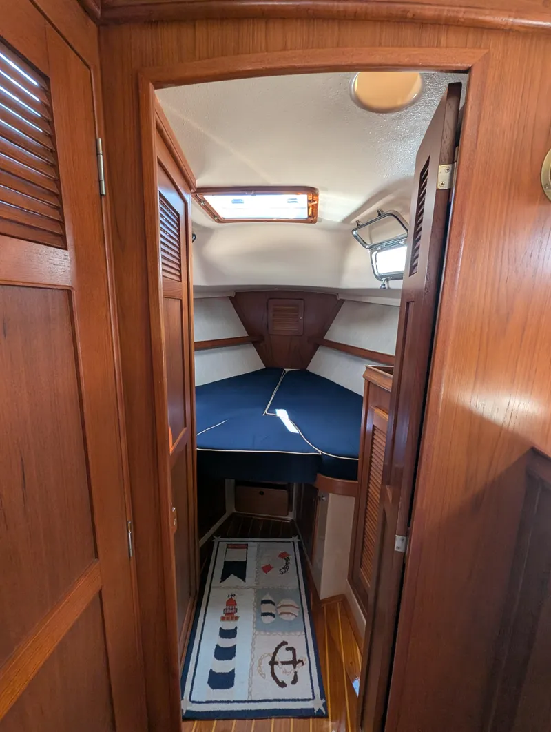 Slide: The Image of 1994 Island Packet 35 sailboat cabin with wooden interior and nautical-themed decor. - 37