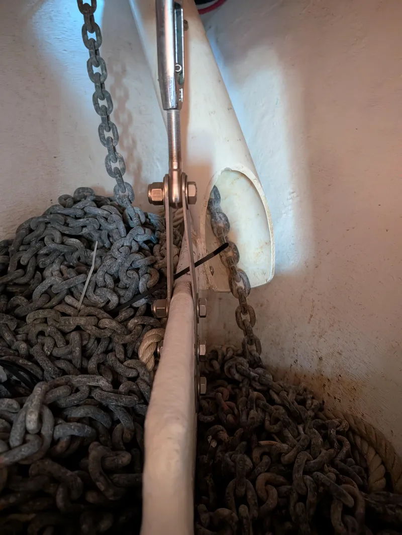 Slide: The Image of Anchor chain and hardware inside a 1994 Island Packet 35 sailboat. - 43