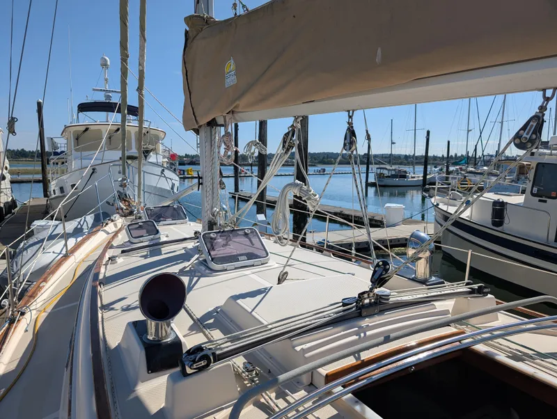 Slide: The Image of 1994 Island Packet 35 sailboat docked at a marina on a sunny day. - 5