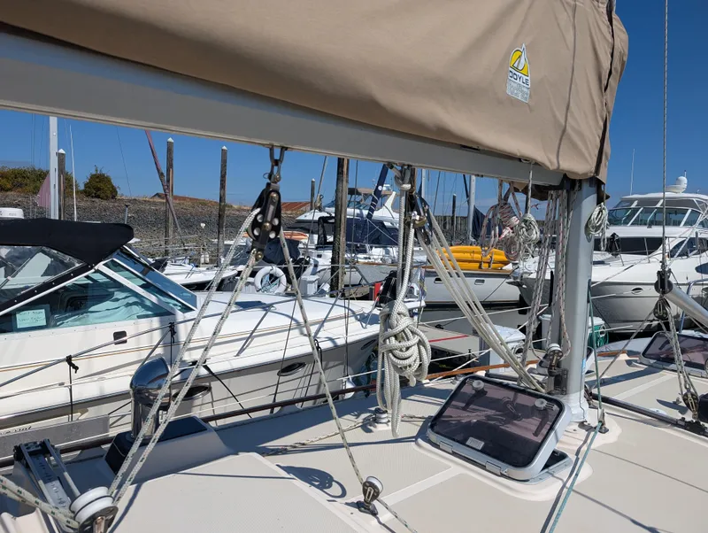 Slide: The Image of 1994 Island Packet 35 sailboat docked, featuring rigging and deck details. - 7