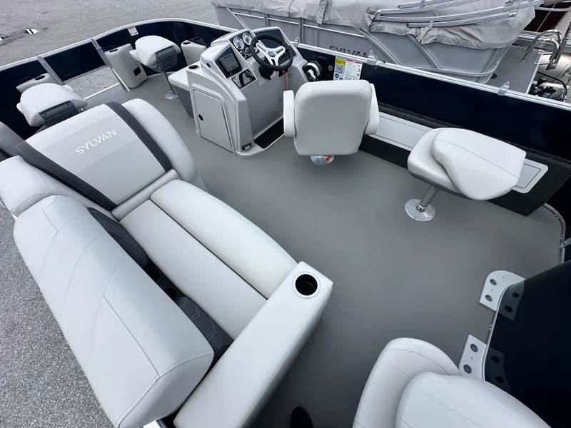 Slide: The Image of 2026 Sylvan Mirage Fish 820 Party Fish 4.0 interior with plush seating and modern dashboard. - 3