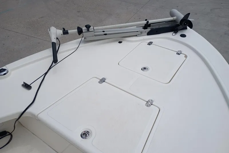 Slide: The Image of 2018 Mako 18 LTS boat deck with trolling motor and storage compartments. - 11