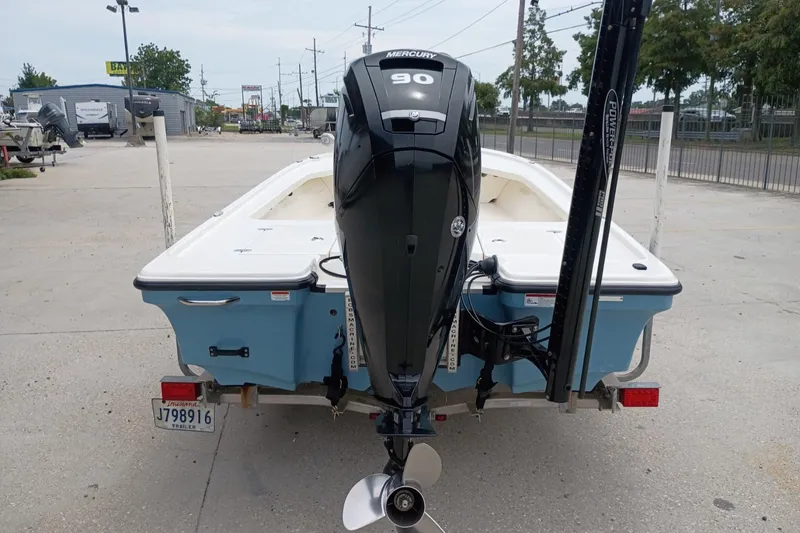 Slide: The Image of 2018 Mako 18 LTS boat with Mercury 90 engine on trailer, parked outdoors. - 3