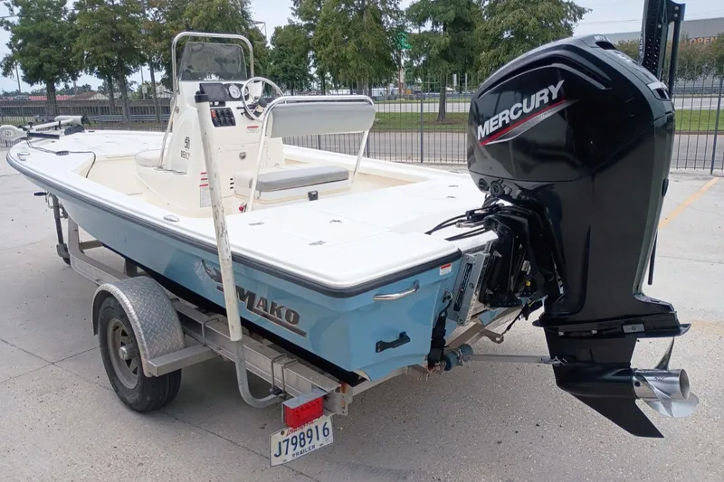 Slide: The Image of 2018 Mako 18 LTS boat with Mercury outboard motor on a trailer. - 4