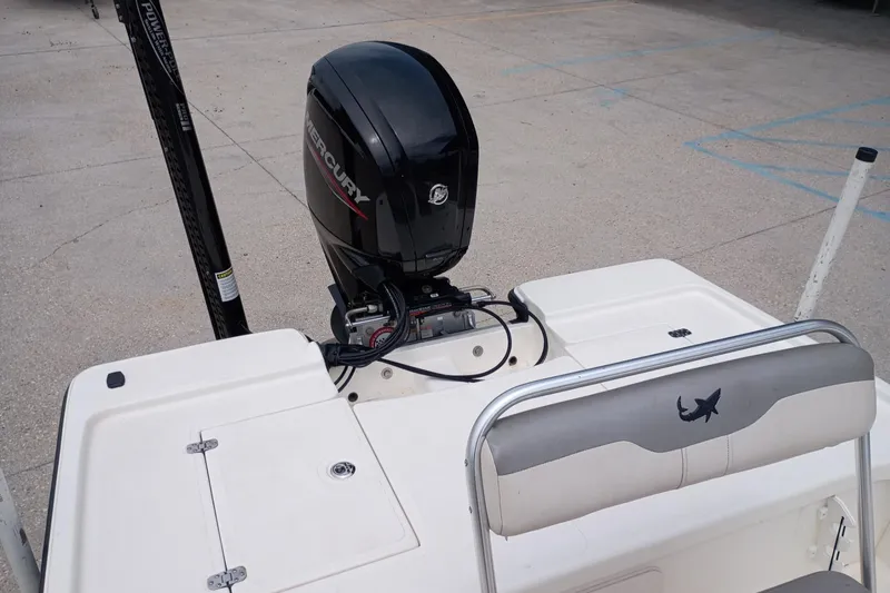 Slide: The Image of 2018 Mako 18 LTS boat with Mercury outboard motor, rear seating, and storage compartment. - 5