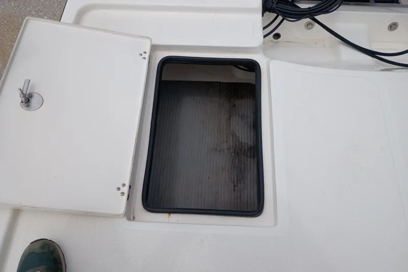 Slide: The Image of Open storage compartment on a 2018 Mako 18 LTS boat deck. - 7