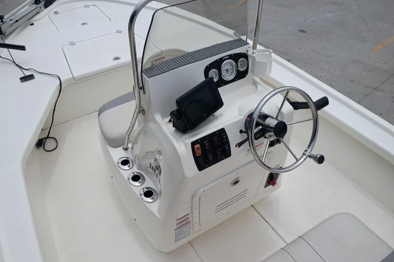 Slide: The Image of 2018 Mako 18 LTS boat console with steering wheel and control panel. - 9