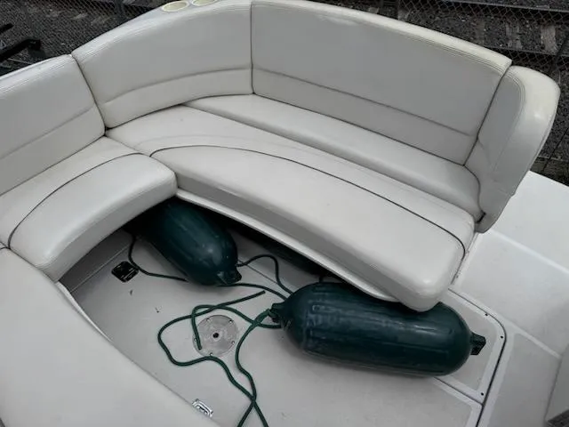 Slide: The Image of 2001 Four Winns 248 Vista boat interior with white seating and green fenders. - 11