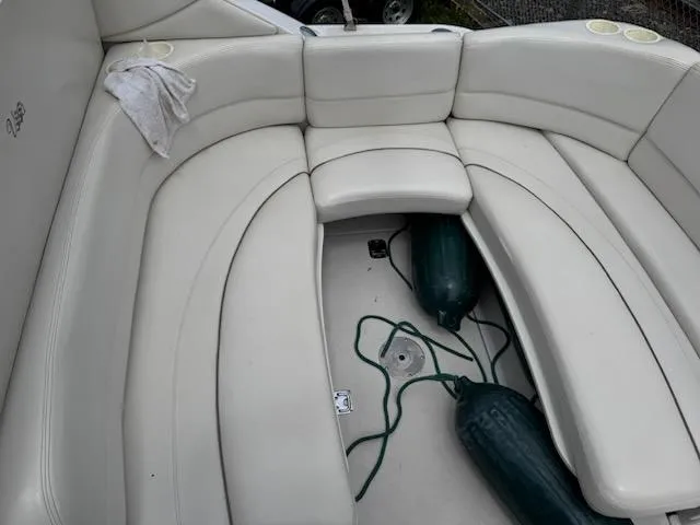 Slide: The Image of 2001 Four Winns 248 Vista boat interior with white seating and green fenders. - 12