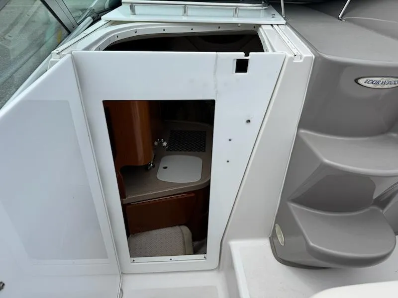 Slide: The Image of 2001 Four Winns 248 Vista boat interior with cabin entry and compact sink. - 14