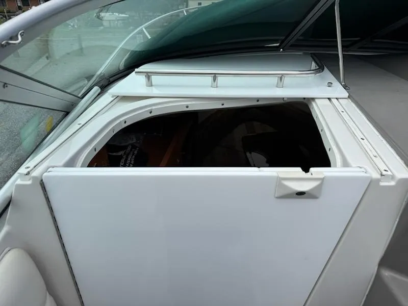 Slide: The Image of 2001 Four Winns 248 Vista boat cabin entrance with open hatch and white door. - 15