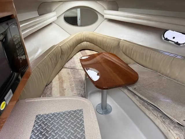 Slide: The Image of 2001 Four Winns 248 Vista cabin interior with seating and wooden table. - 17