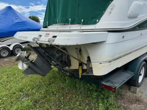 Slide: The Image of 2001 Four Winns 248 Vista boat on trailer, rear view with propeller, green cover. - 6