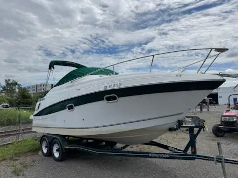 Slide: The Image of 2001 Four Winns 248 Vista boat on trailer under cloudy sky. - 8