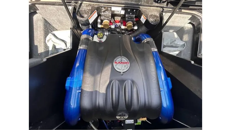 Slide: The Image of 2017 MasterCraft X23 Ilmor engine with blue accents in boat compartment. - 26