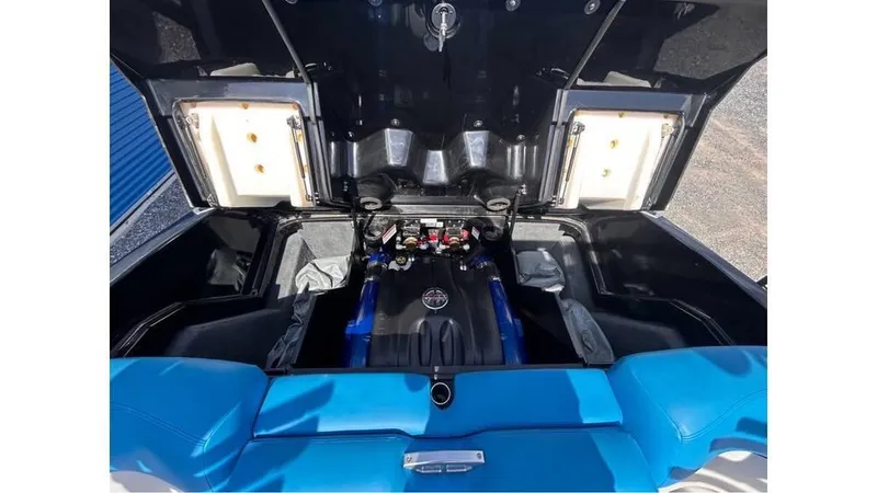 Slide: The Image of 2017 MasterCraft X23 engine compartment with blue seating and open hatch. - 27