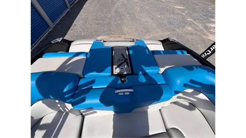Slide: The Image of 2017 MasterCraft X23 boat interior with blue and white seating. - 29