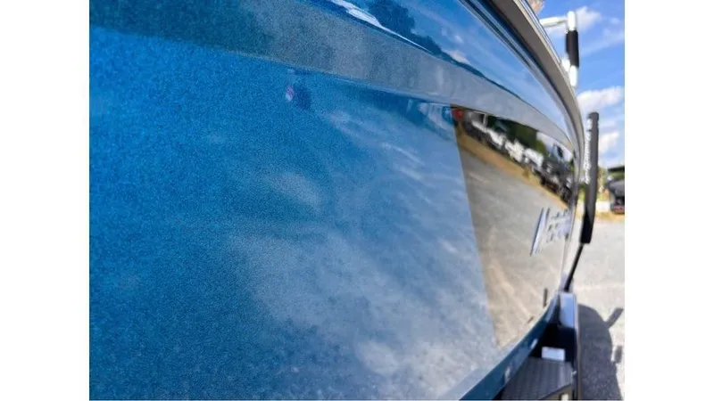 Slide: The Image of 2017 MasterCraft X23 boat with shiny blue exterior reflecting surroundings. - 3