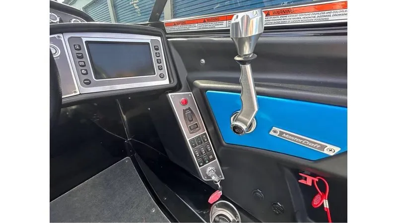 Slide: The Image of 2017 MasterCraft X23 boat dashboard with control panel and gear lever. - 9