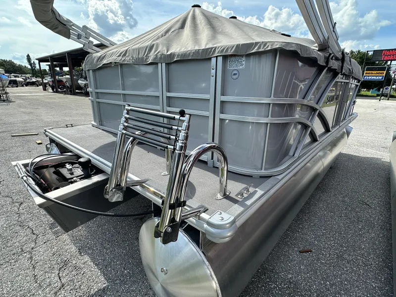 Slide: The Image of 2025 Sylvan Mirage 818 Cruise pontoon boat with ladder, parked outdoors. - 2