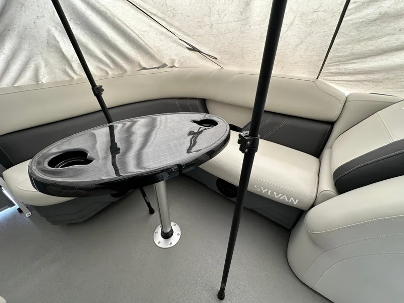 Slide: The Image of Luxurious interior of 2025 Sylvan Mirage 818 Cruise with sleek seating and modern table design. - 20