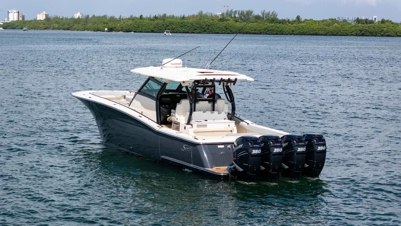 Slide: The Image of 2020 Scout 380 LXF boat with four Mercury engines on a calm waterway. - 10