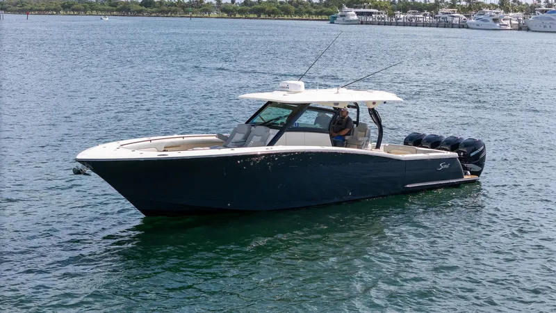 Slide: The Image of 2020 Scout 380 LXF boat on water, featuring sleek design and powerful engines. - 14