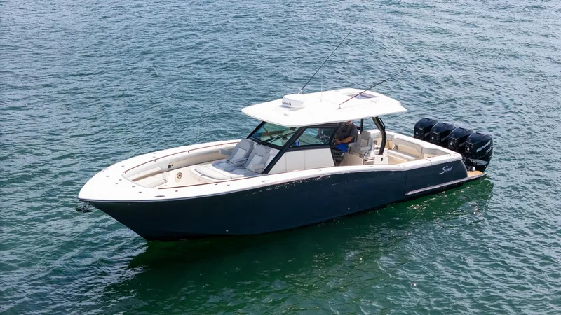 Slide: The Image of 2020 Scout 380 LXF boat on water, featuring sleek design and powerful engines. - 15