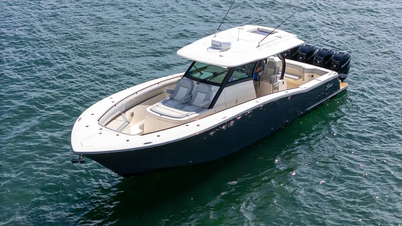 Slide: The Image of 2020 Scout 380 LXF boat on water, featuring sleek design and multiple outboard engines. - 16