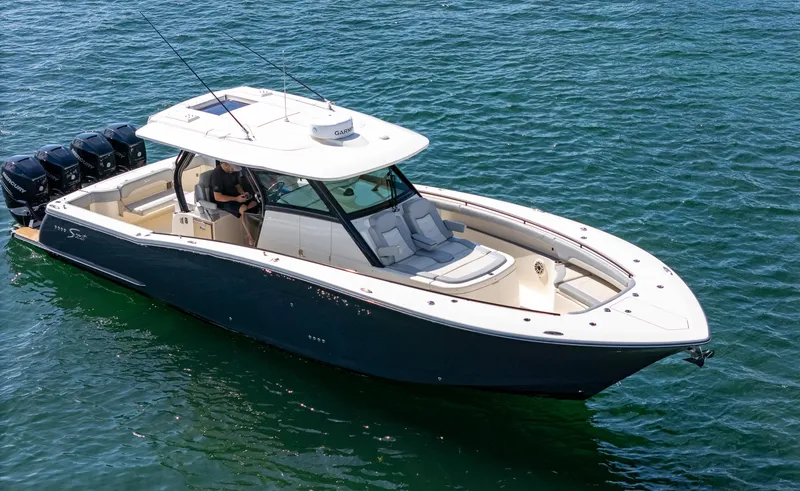 Slide: The Image of 2020 Scout 380 LXF boat cruising on clear blue water. - 18