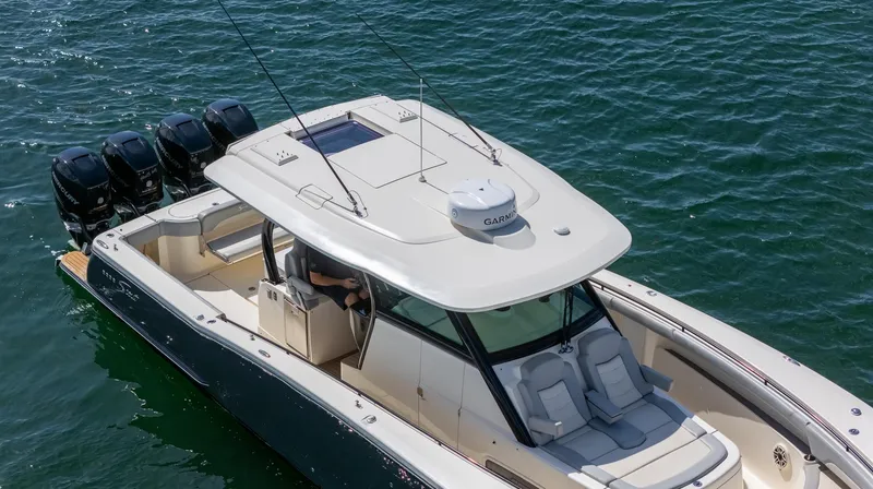 Slide: The Image of 2020 Scout 380 LXF boat on water, featuring sleek design and multiple outboard engines. - 19