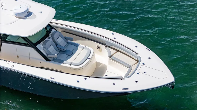 Slide: The Image of 2020 Scout 380 LXF boat on water, featuring sleek design and comfortable seating. - 20