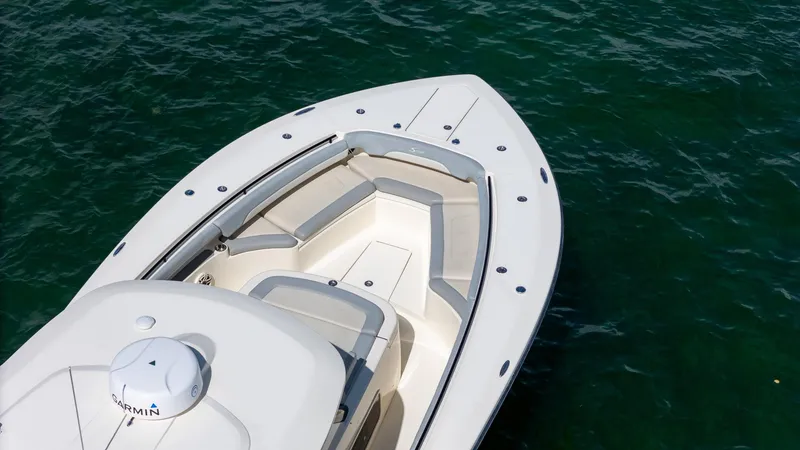 Slide: The Image of 2020 Scout 380 LXF boat on clear water, featuring sleek design and spacious seating. - 21