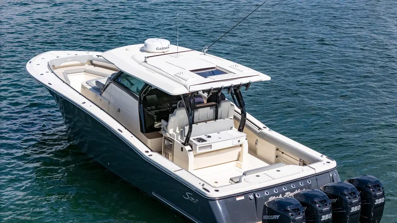 Slide: The Image of 2020 Scout 380 LXF boat on water, featuring sleek design and powerful Mercury engines. - 25